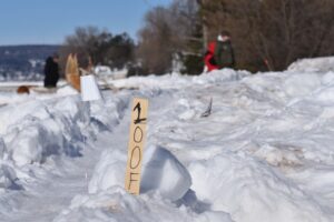 A channel is carved out of snow. It served as the track for competitors to throw their snow snakes down during a Madeline Island festival on Feb. 11, 2023. (Danielle Kaeding/WPR)
