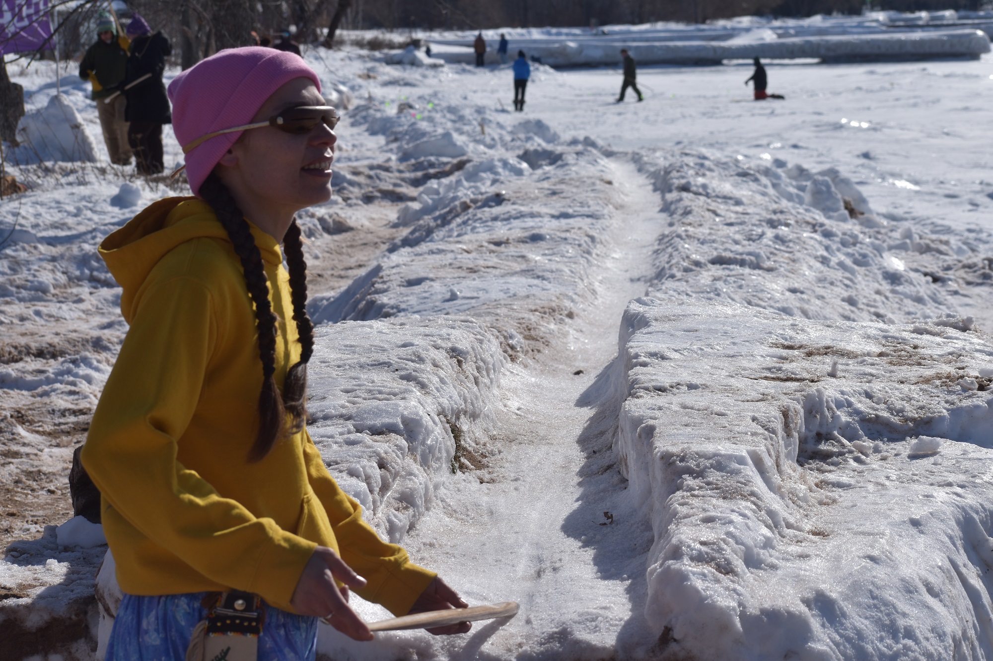 Red Cliff tribal member Sandy Gokee, who goes by the name Wenipashtaabe, clinched the longest throw for women 54 and under at 293.2 feet. She’s pictured wearing what she calls her “super sacred cedar vision” shades on Feb. 11, 2023. (Danielle Kaeding/WPR)