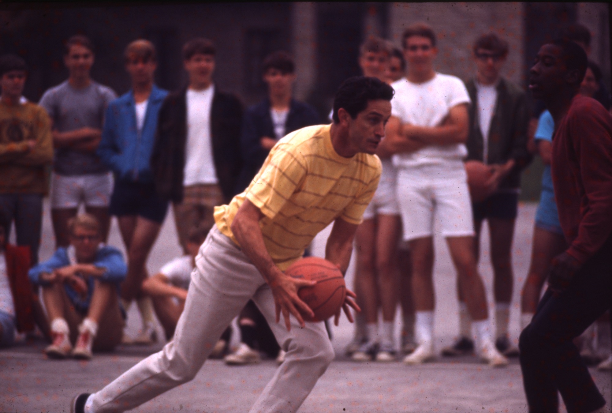 Al McGuire runs with basketball in 1969 or 1970. (Courtesy of the Department of Special Collections and University Archives, Raynor Memorial Libraries, Marquette University)