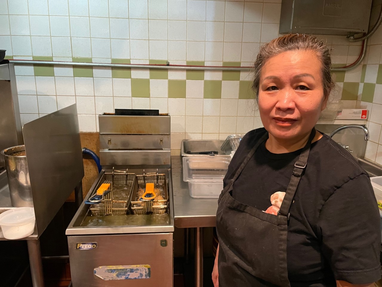 Chef Manola Hoang frying dumplings in the Ahan kitchen on February 8, 2023. (Maureen McCollum/WPR)