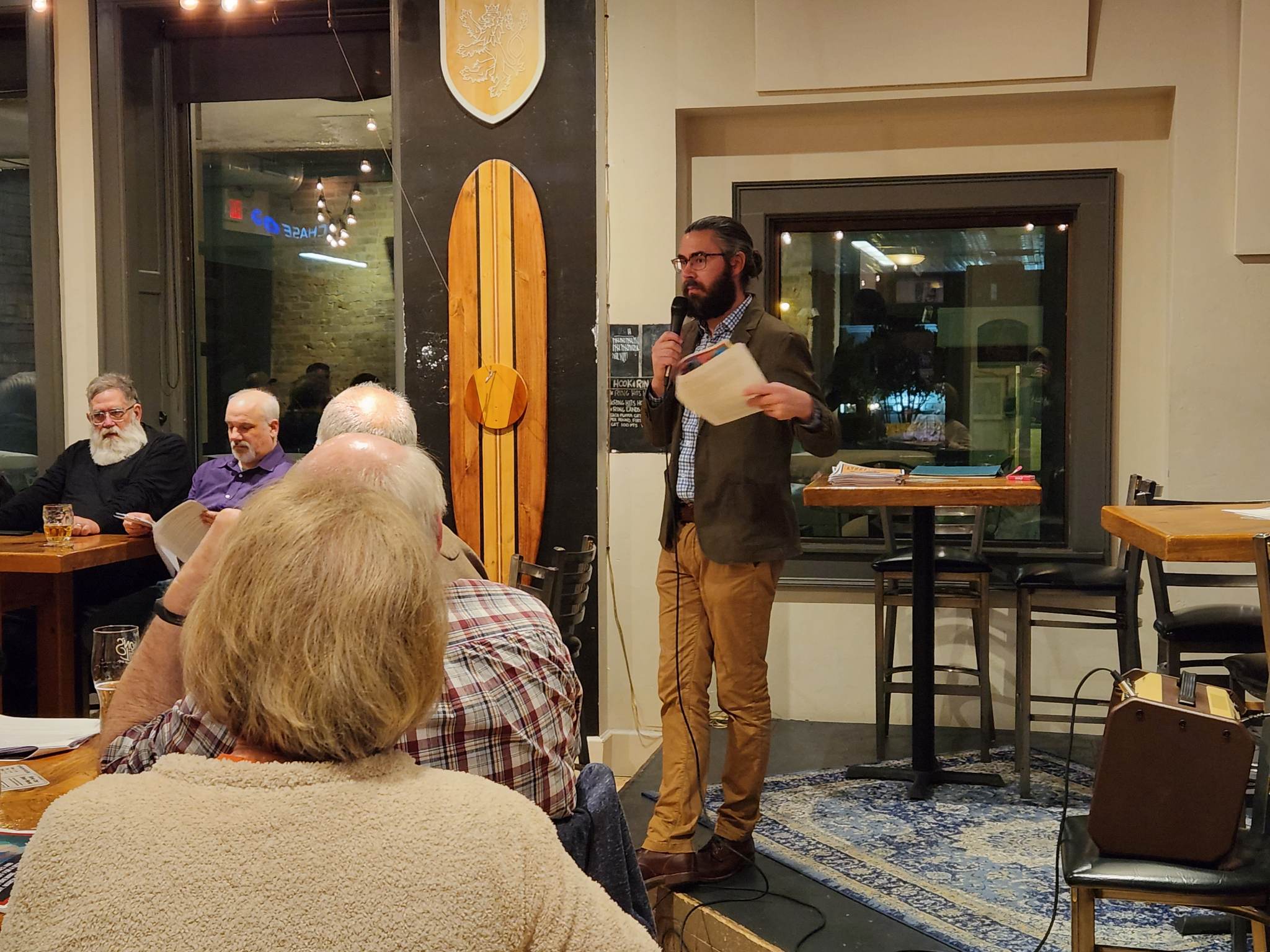 Neenah Public Library Librarian Richie Zaborowske leads a group discussion at one of the library’s monthly Short Story Nights at Lion's Tail Brewing. (Joe Schulz/WPR)