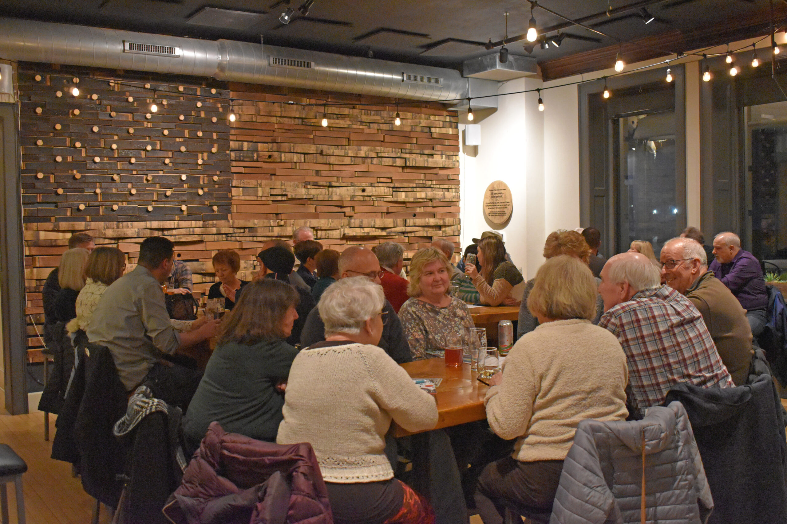 Each month, Fox Valley residents fill a room at Lion's Tail Brewing in Neenah for Short Story Nights, an event where folks discuss a different short story each month. (Joe Schulz/WPR)