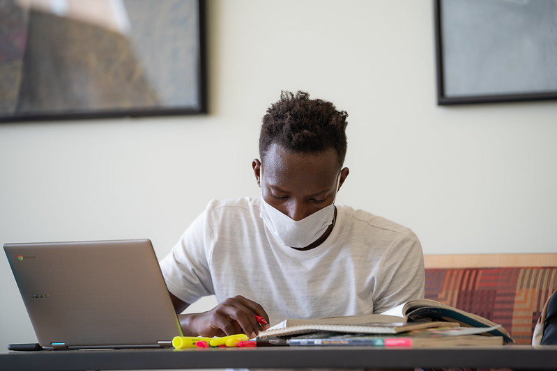 A UW-Oshkosh student wears a mask as he studies for classes. The university implemented numerous safety measures when students returned to campus in fall 2020. (Courtesy of UW-Oshkosh)