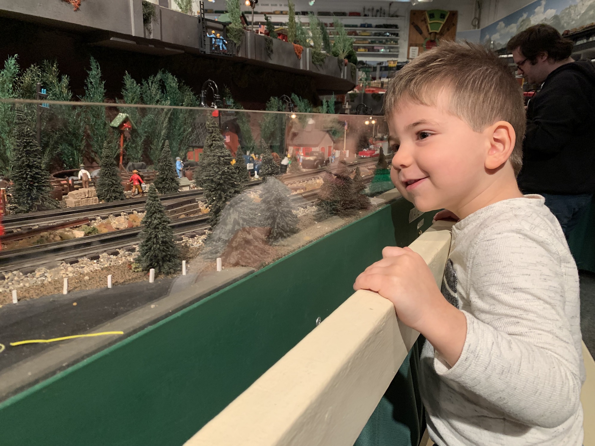A young boy smiles as he watches model trains at the Lionel Railroad Club's open house. (Photo by Jane Hampden)