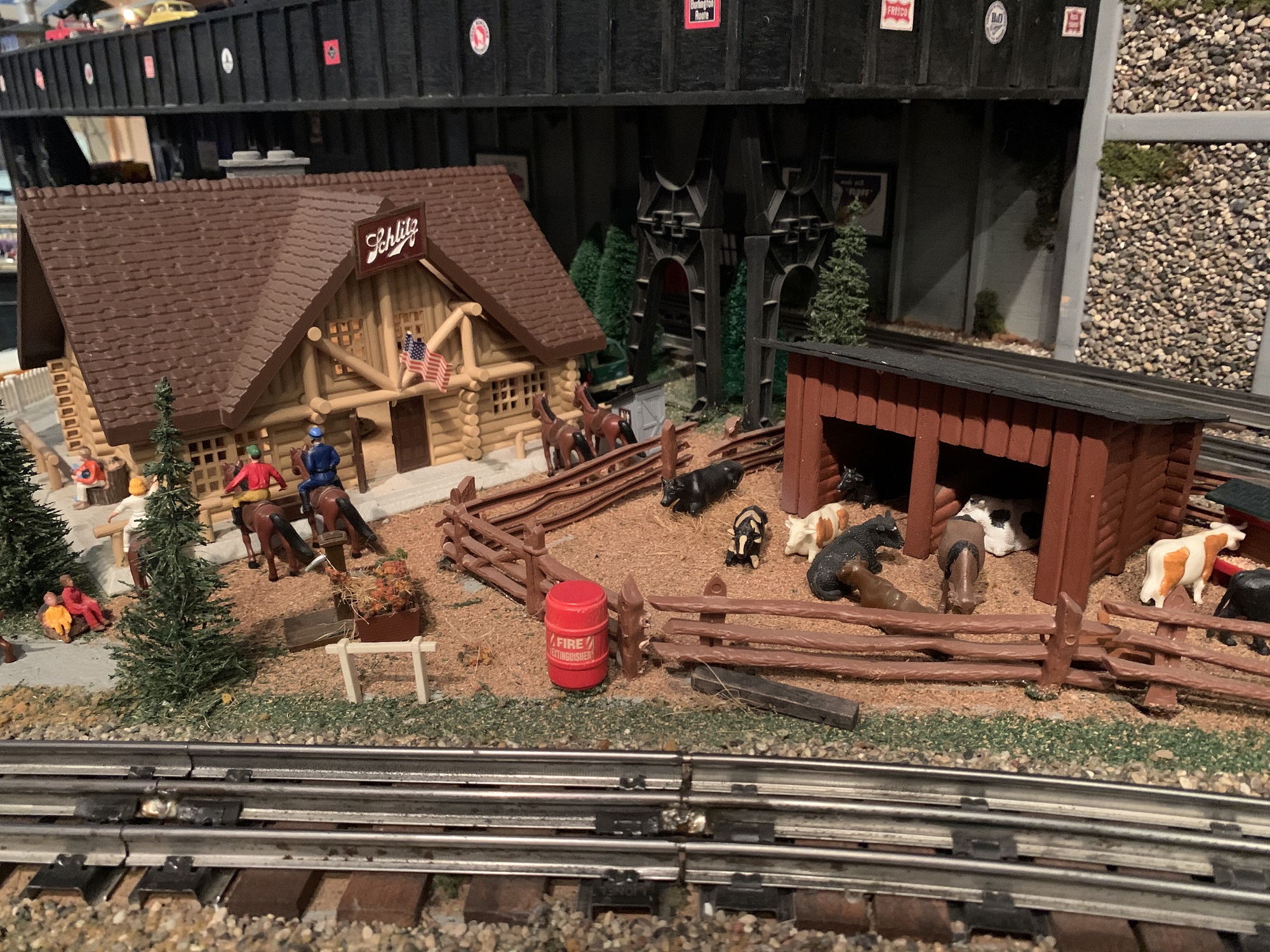 A diorama featuring a Schlitz cabin and farm animals is one of the many elements that makes up the Lionel Railroad Club's mini world. (Photo by Jane Hampden.)