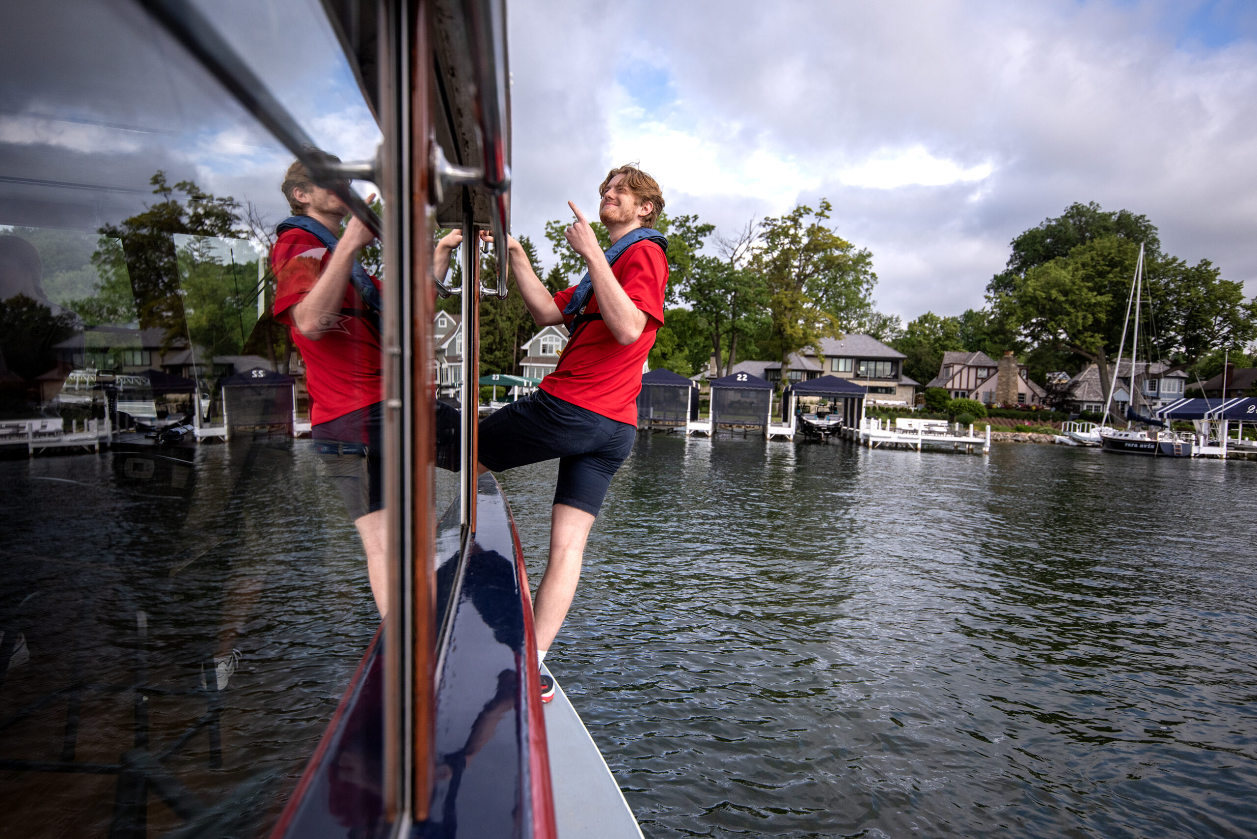 Ethan Connelly of Walworth, Wis., rides on the front of the boat before demonstrating a successful mailboat jump Tuesday, June 13, 2023, in Lake Geneva, Wis. (Angela Major/WPR)
