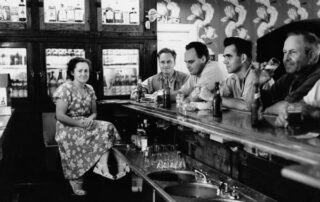 Bartender Rita Koecher serves patrons: Russ Bandlow, Les Beck, and unknown patrons in a Theresa, Wisconsin bar in 1949. (Courtesy of the Wisconsin Historical Society)