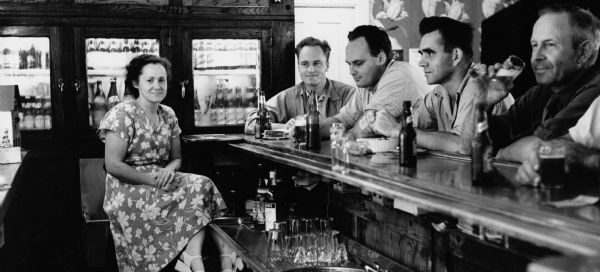 Bartender Rita Koecher serves patrons: Russ Bandlow, Les Beck, and unknown patrons in a Theresa, Wisconsin bar in 1949. (Courtesy of the Wisconsin Historical Society)