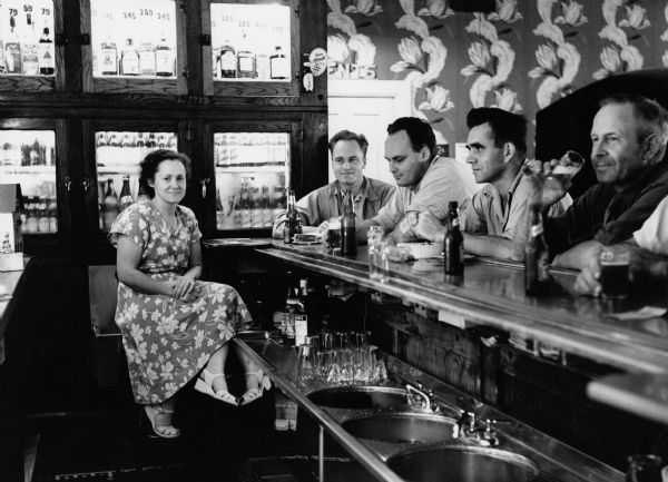 Bartender Rita Koecher serves patrons: Russ Bandlow, Les Beck, and unknown patrons in a Theresa, Wisconsin bar in 1949. (Courtesy of the Wisconsin Historical Society)