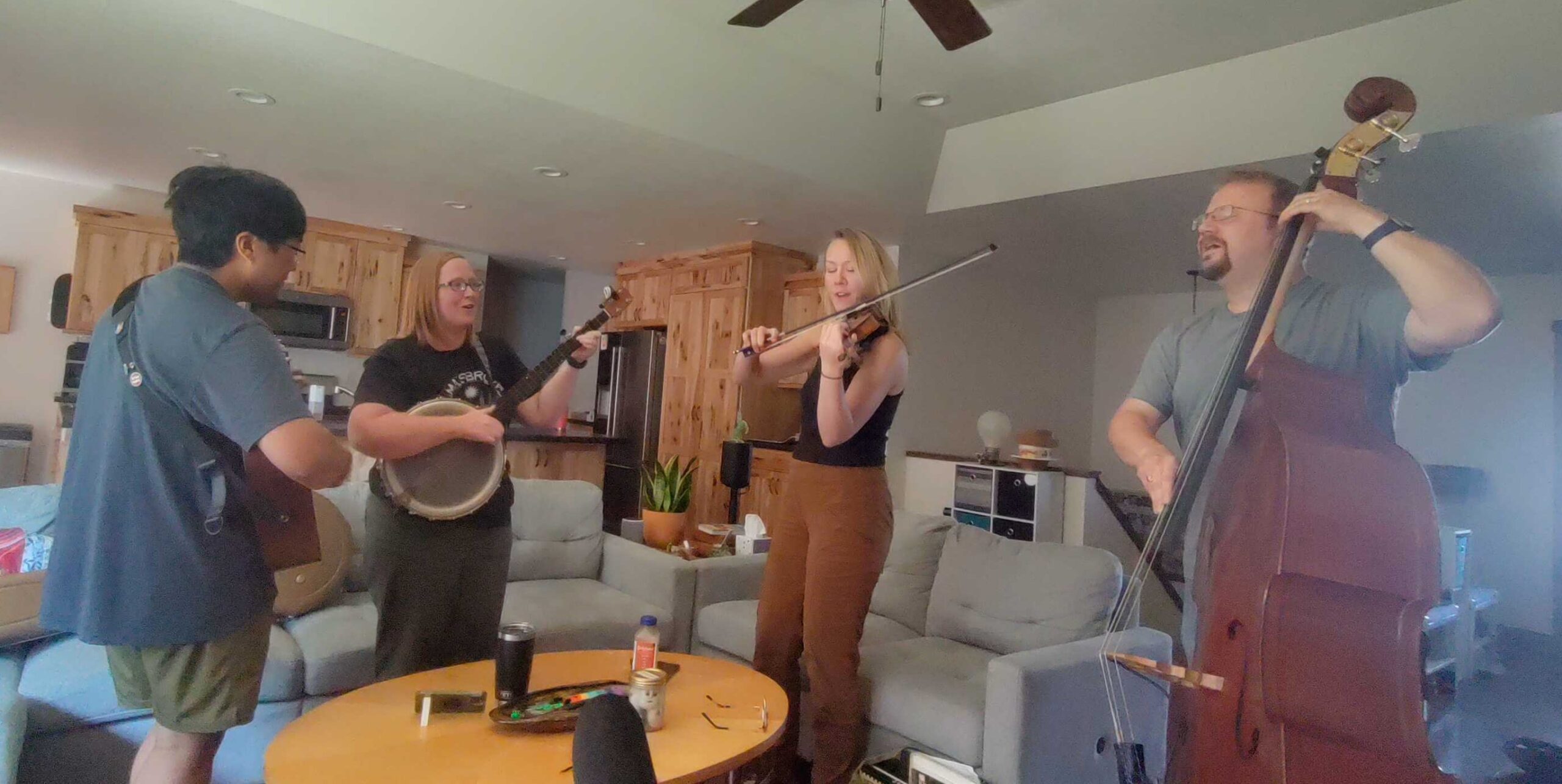 Members of Crooked Willow practice before their upcoming performance at Larryfest in 2023. l-r Tim Waller, Elisi Smith Waller, Jessie McDonald, and Erik Hanson. (Ezra Wall/WPR)