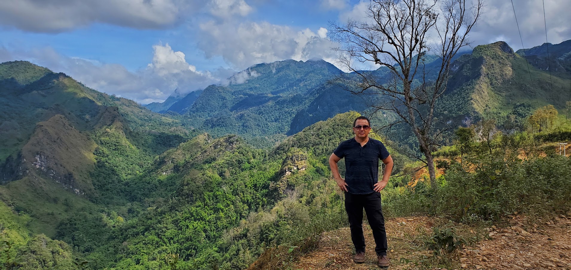 Pao Lor stands near Phou Bia, the tallest mountain in Laos in November 2022. This is near where his father was assassinated. (Courtesy of Pao Lor)