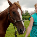 Founder of sanctuary with horse.