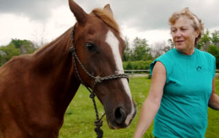 Founder of sanctuary with horse.