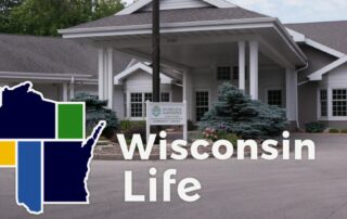 Wisconsin Life logo in front of building.