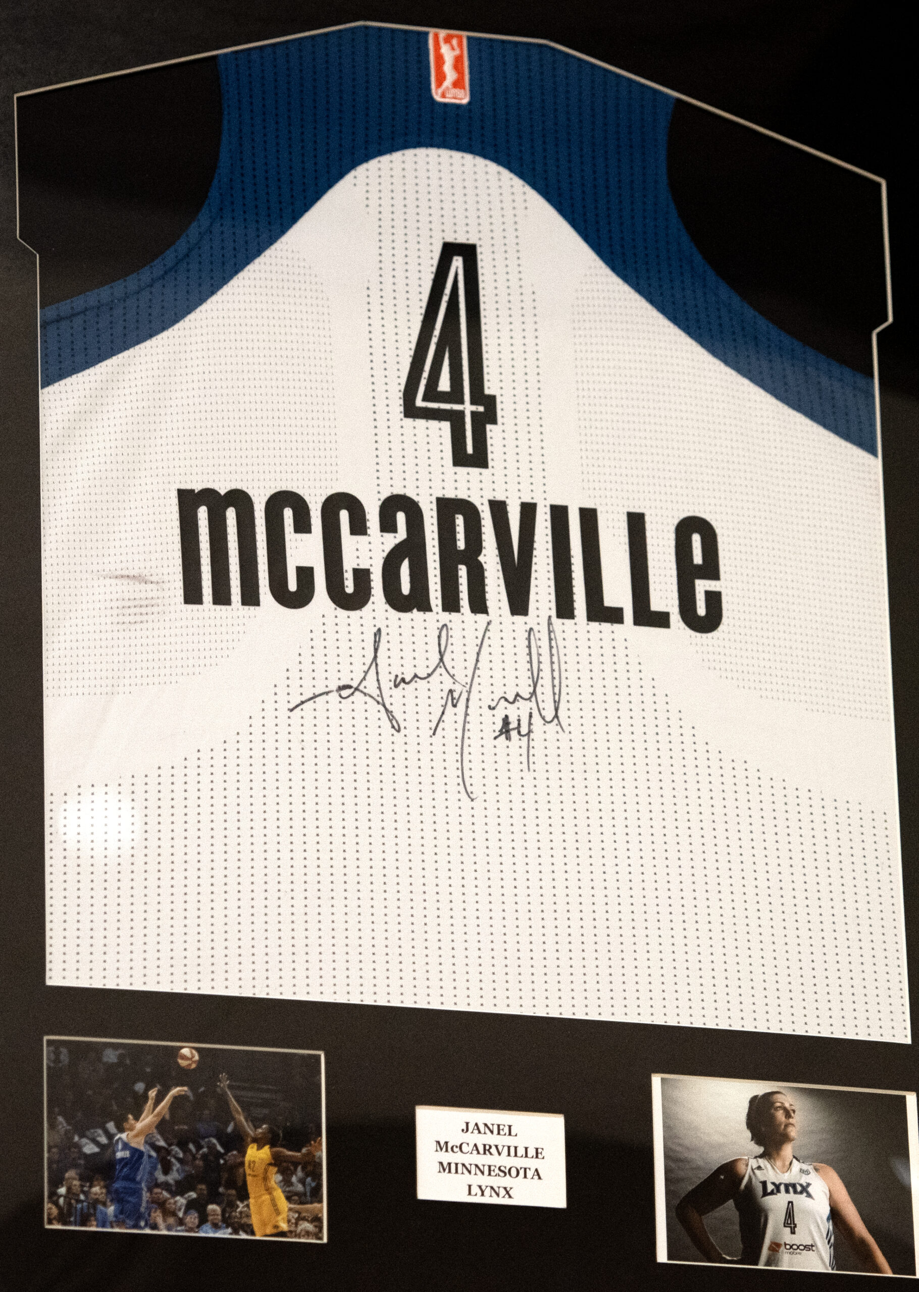 Janel McCarville’s autographed jersey hangs outside the gymnasium on Thursday, Nov. 9, 2023, at Stevens Point Area Senior High in Stevens Point, Wisconsin. (Angela Major/WPR)