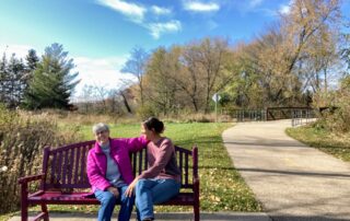 Chris Thomas and Alexandra Salmon sit on a bench in Madison, Wisconsin. Chris would like to establish a similar one in a park as her memorial bench. (Photo by Alexandra Salmon)