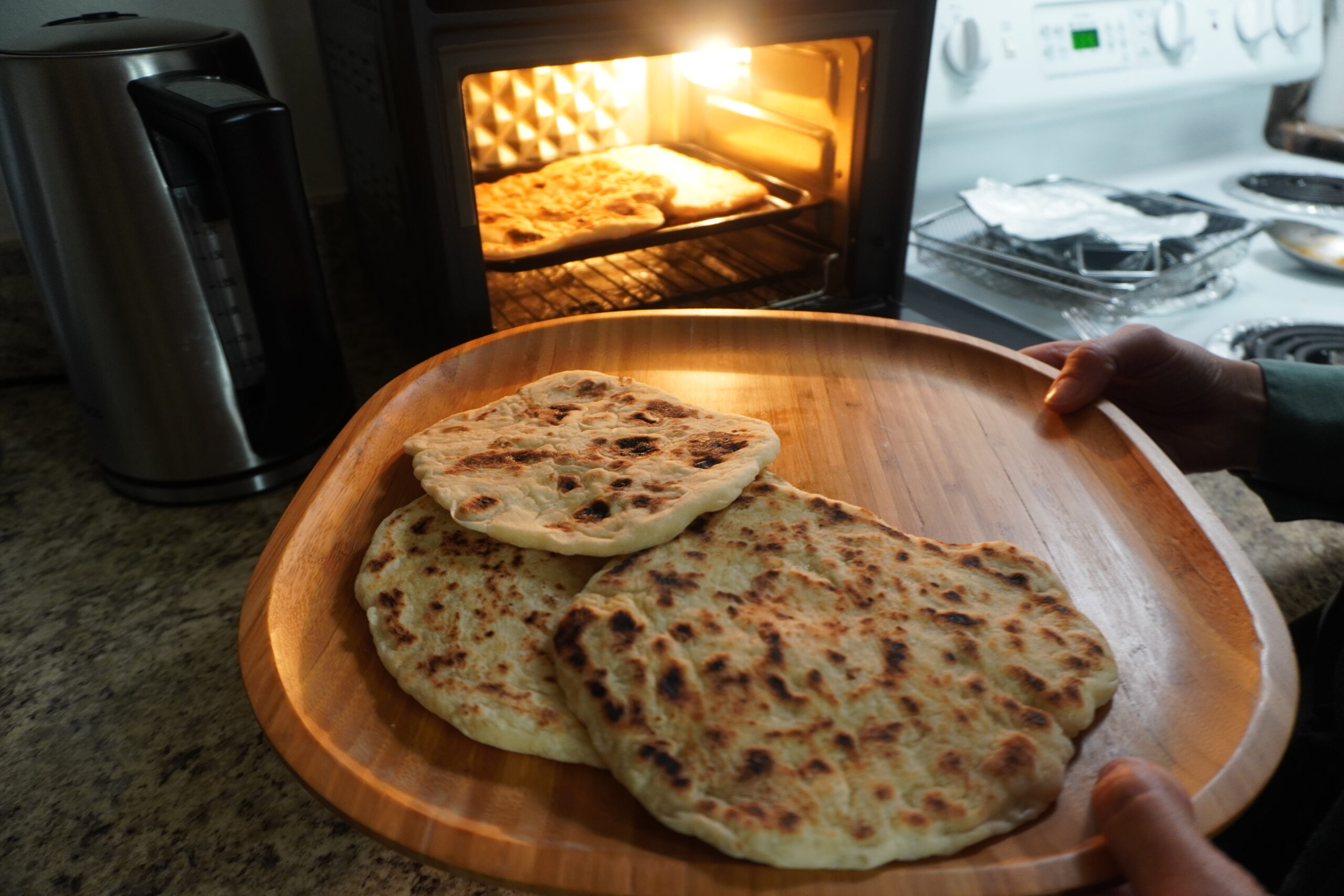 Pita bread being toasted in the oven.