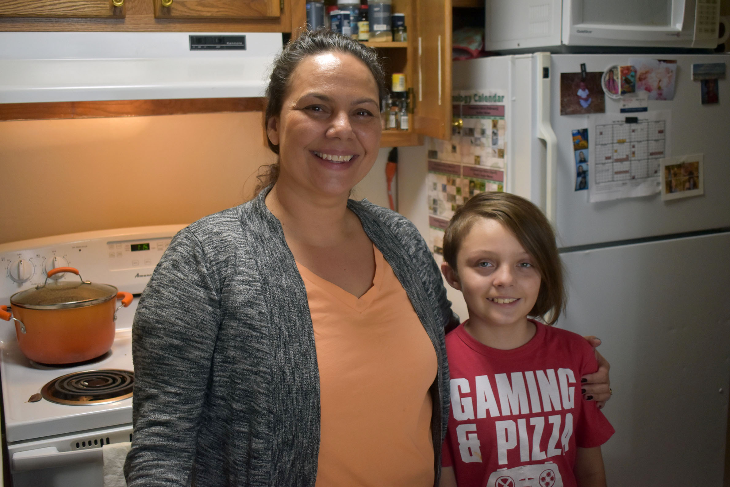 Sarah Gordon Altiman and her son, Jason, stand in the kitchen where she prepared Potawatomi-style corn soup on Dec. 21, 2023. She says these traditional dishes are some of her kids’ favorite foods. (Danielle Kaeding/WPR)