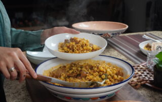 Hassen serves Mbakbaka to share with friends.