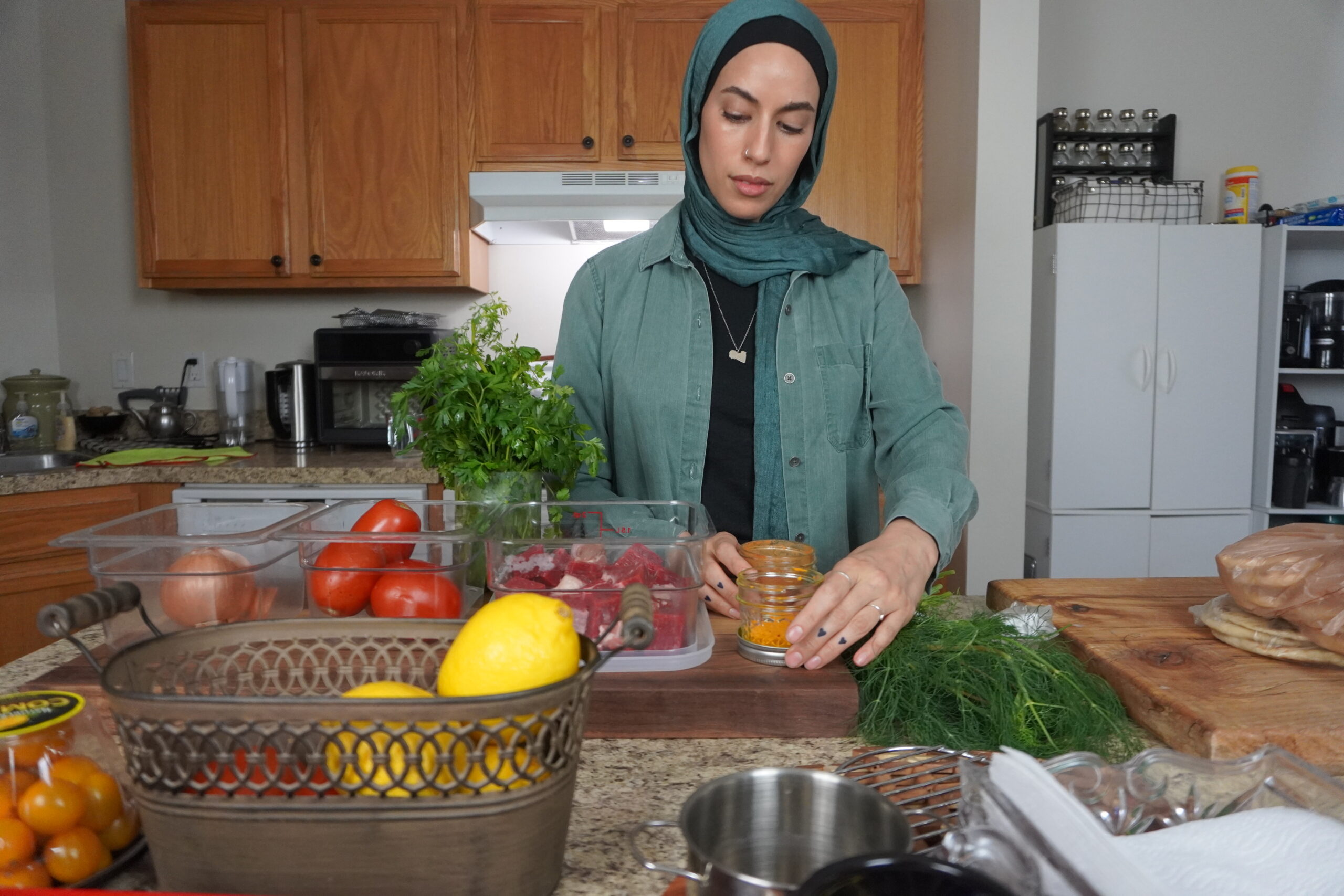 Zainab Hassen prepares ingredients to make Mbakbaka in her home kitchen in Stoughton, Wis.