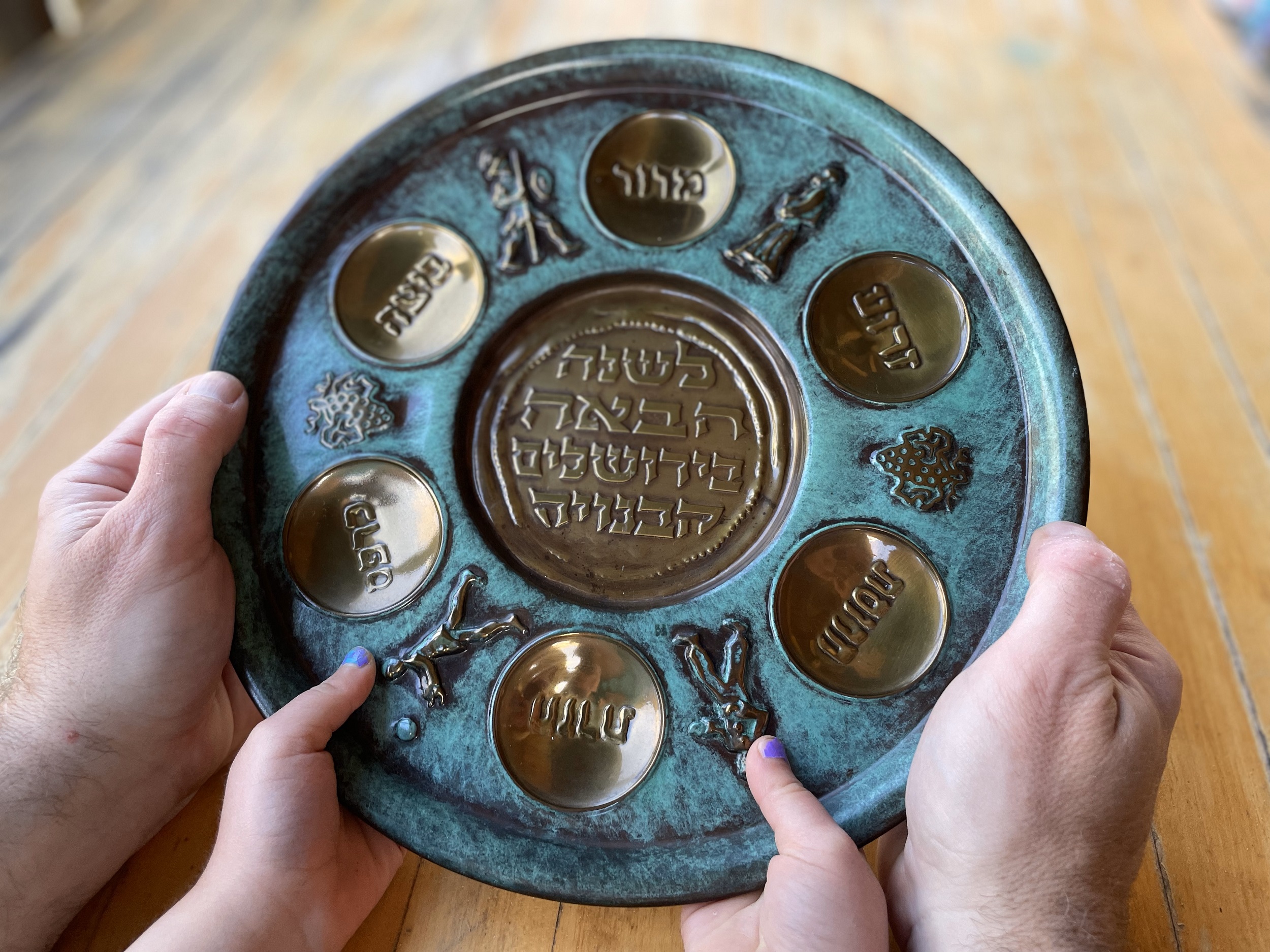 Mark E. Griffin and his daughter hold the family's seder plate, which belonged to her great grandmother, Lillian Motew. (Photo by Melissa Motew)