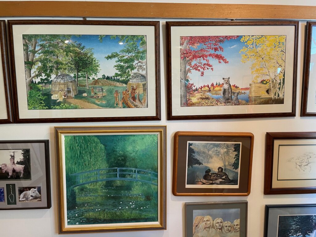 Paintings by Harry Whitehorse take up a wall in the Whitehorse Gallery in Monona, Wisconsin. (Maureen McCollum/WPR)