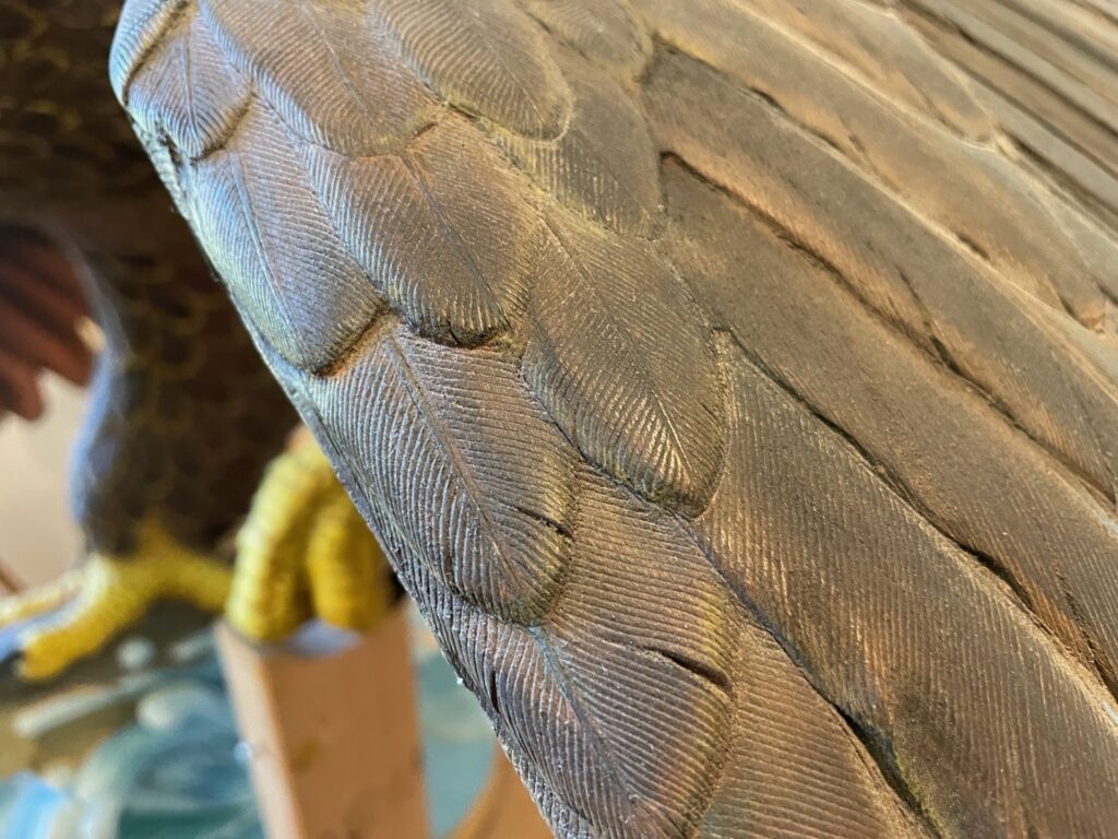 A closeup on "Fishing Eagle" by Harry Whitehorse shows how the intricate carving of the feather makes it appear real. (Maureen McCollum/WPR)