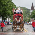 Horses lead a float in Baraboo’s Big Top Parade on Saturday, June 8, 2024, in Baraboo, Wis. (Angela Major/WPR)