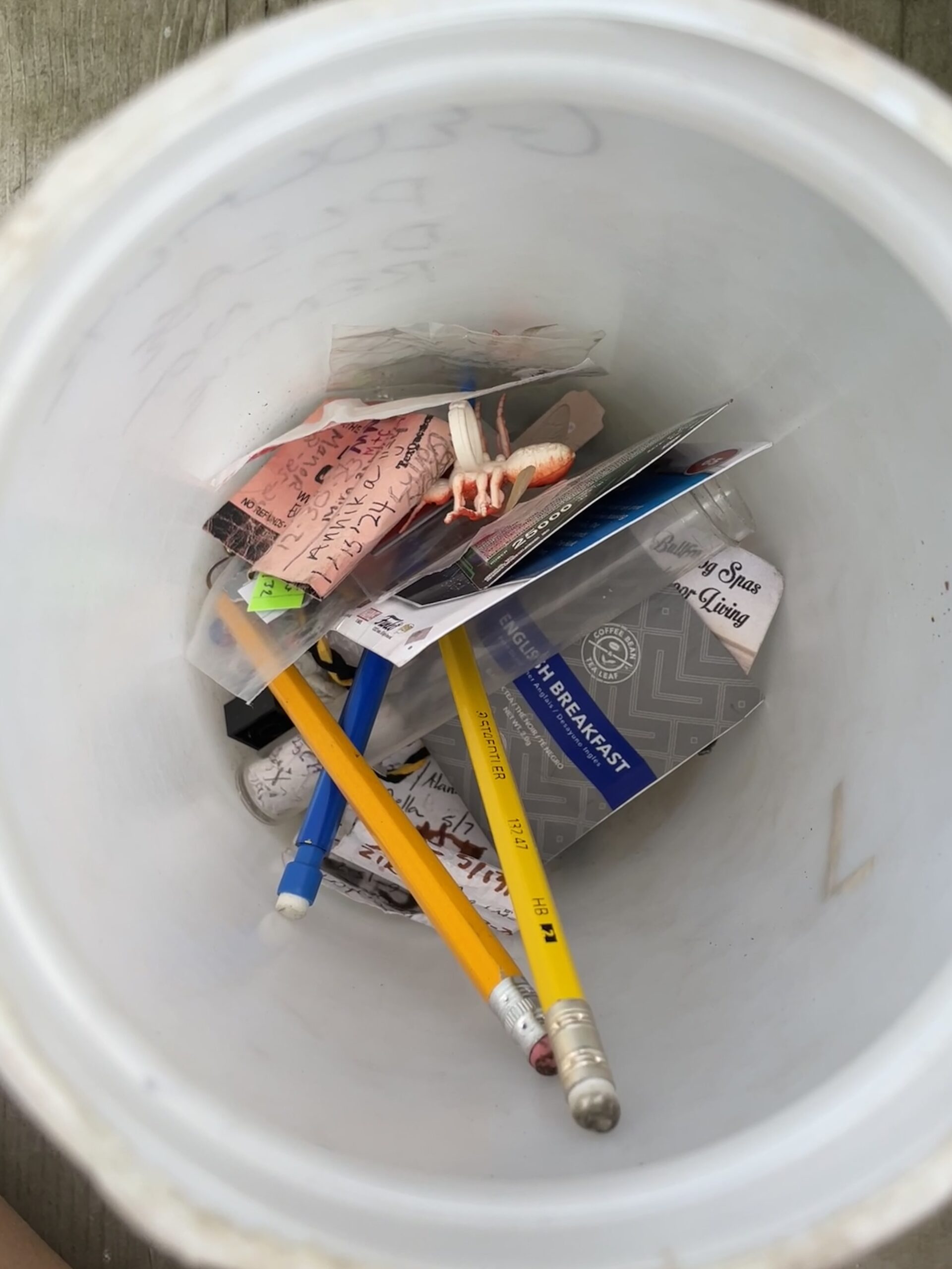 A canister full of trinkets that writer Yia Lor came across while geocaching, an activity her sister, Jer Lor, loved to do. Photo by Yia Lor