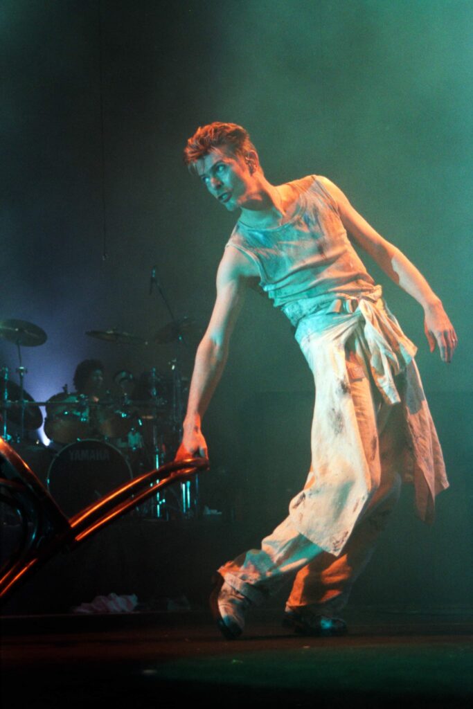 David Bowie performs at a concert. Photo by Marty Sosnowski