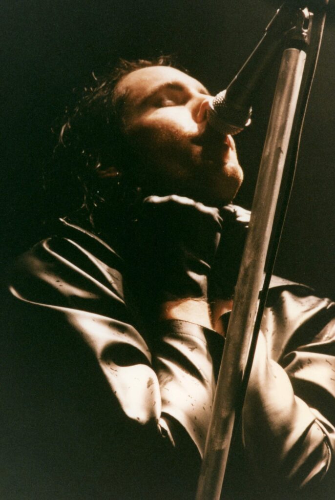 Nine Inch Nails' Trent Reznor sings at a concert. Photo by Marty Sosnowski