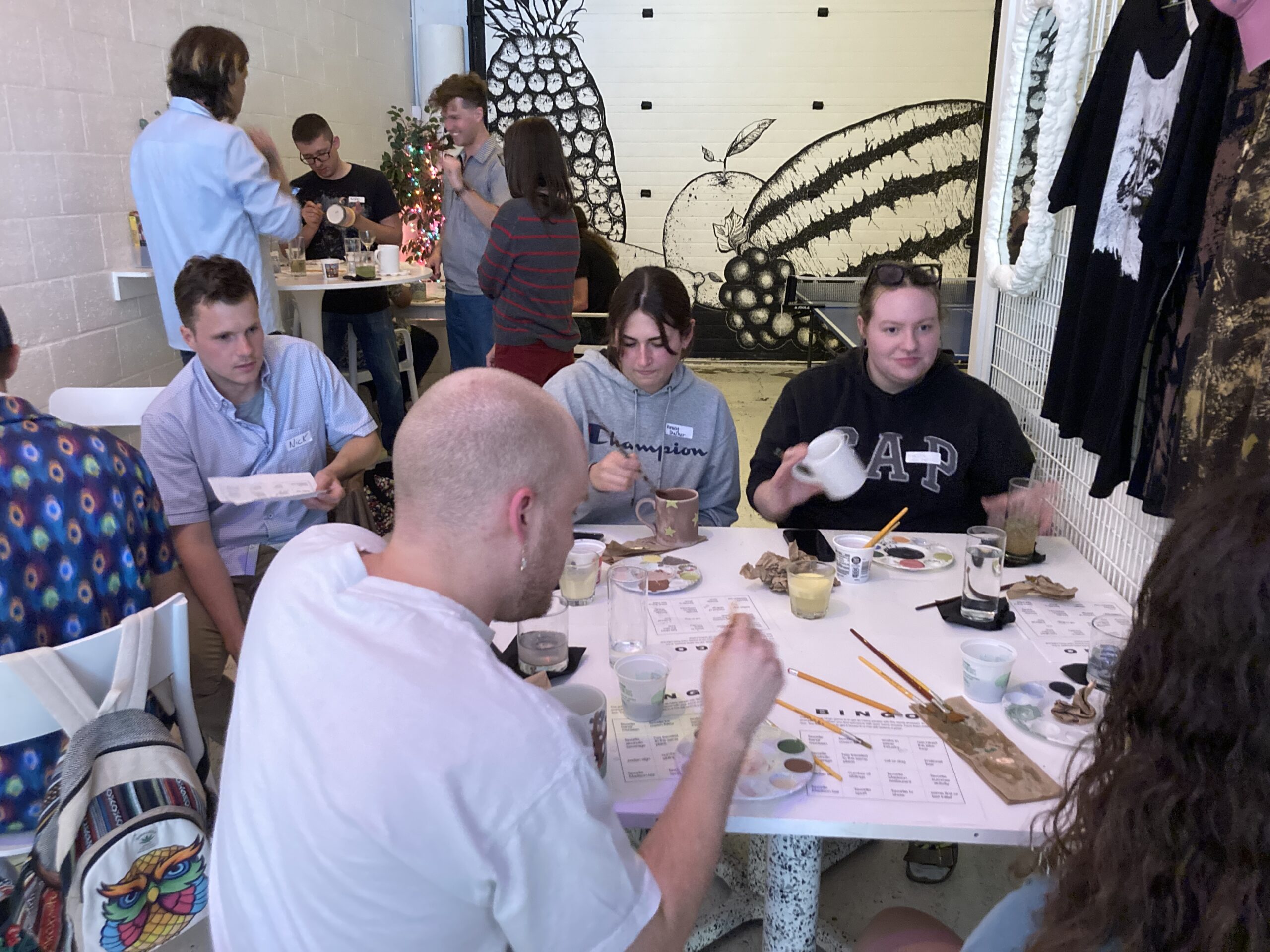 People sit around a table engaged in an art activity