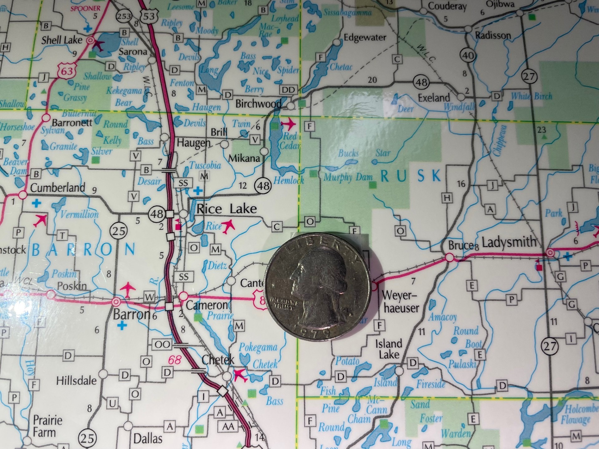 A 1979 quarter poses on a map of Wisconsin next to Weyerhaeuser, where writer Ron Weber lives.<i>Maureen McCollum/WPR</i>